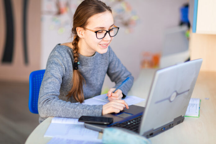 Young,School,Girl,Left-handed,Working,At,Home,In,Her,Room