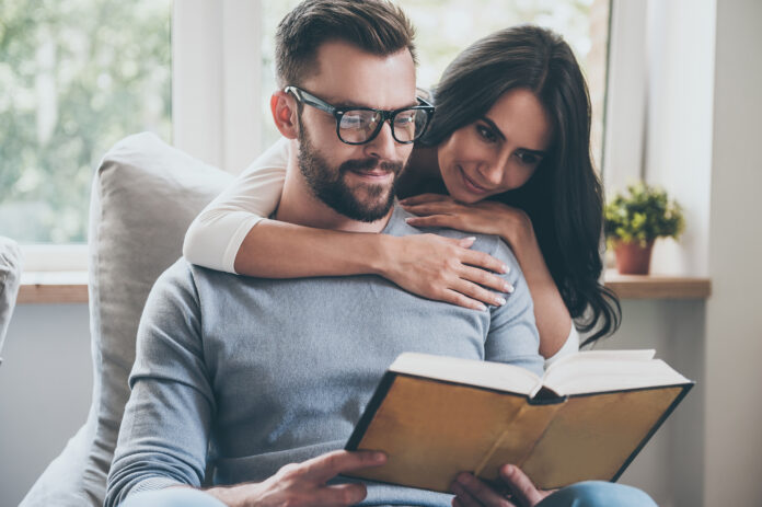 Reading their favorite book. Beautiful young woman bonding to he