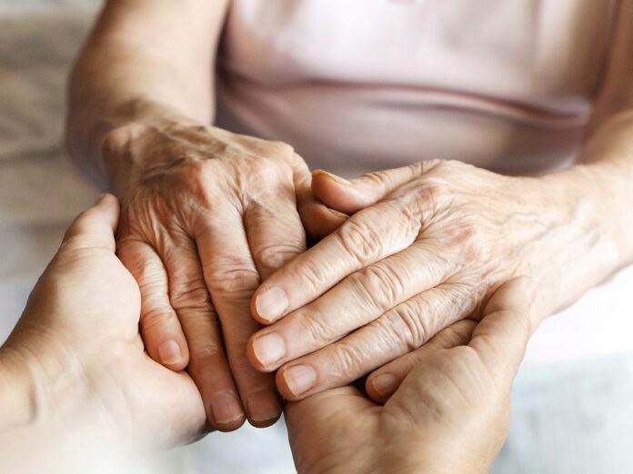 Mature Female In Elderly Care Facility Gets Help From Hospital P