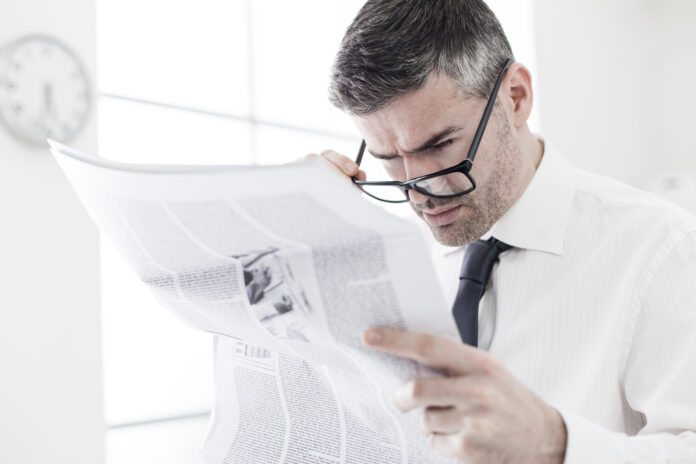 Businessman,In,The,Office,,Reading,Bad,Breaking,News,On,A