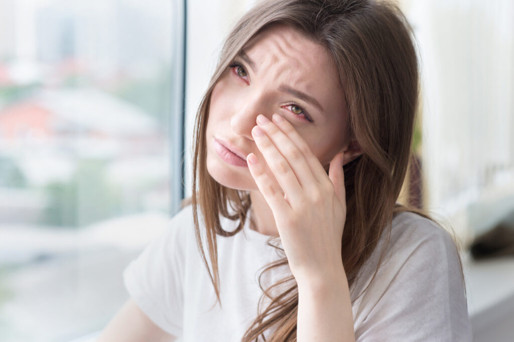 Young,Sad,Woman,Sits,Alone,Front,Of,The,Window.,Crying thumbnail