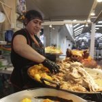 María Chocho, comerciante del mercado 10 de Agosto, prepara un plato de hornado. Esta comida es característica de la ciudad de Cuenca. XCA