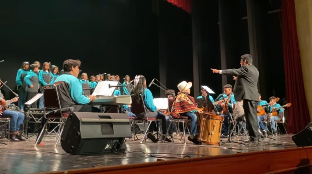 El maestro Wilmer Jumbo, dirige a los estudiantes de las “Orquestas Escolares”, durante el concierto ofrecido en el Teatro de la Casa de la Cultura.