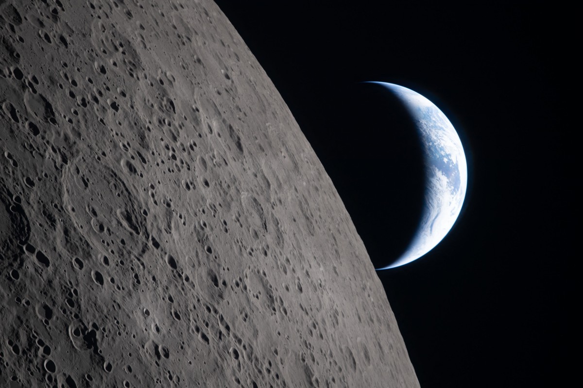Vista de la superficie lunar y de la Tierra desde la nave Orion. Foto: AFP